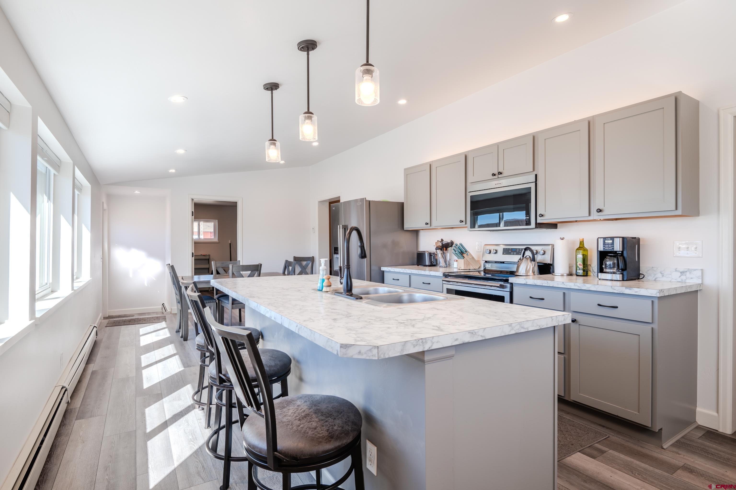 43950 Highway 50 Gunnison, CO 81230 - Photo 7 of 45 a kitchen with a dining table chairs sink and cabinets