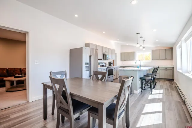 a view of a dining room with furniture and wooden floor