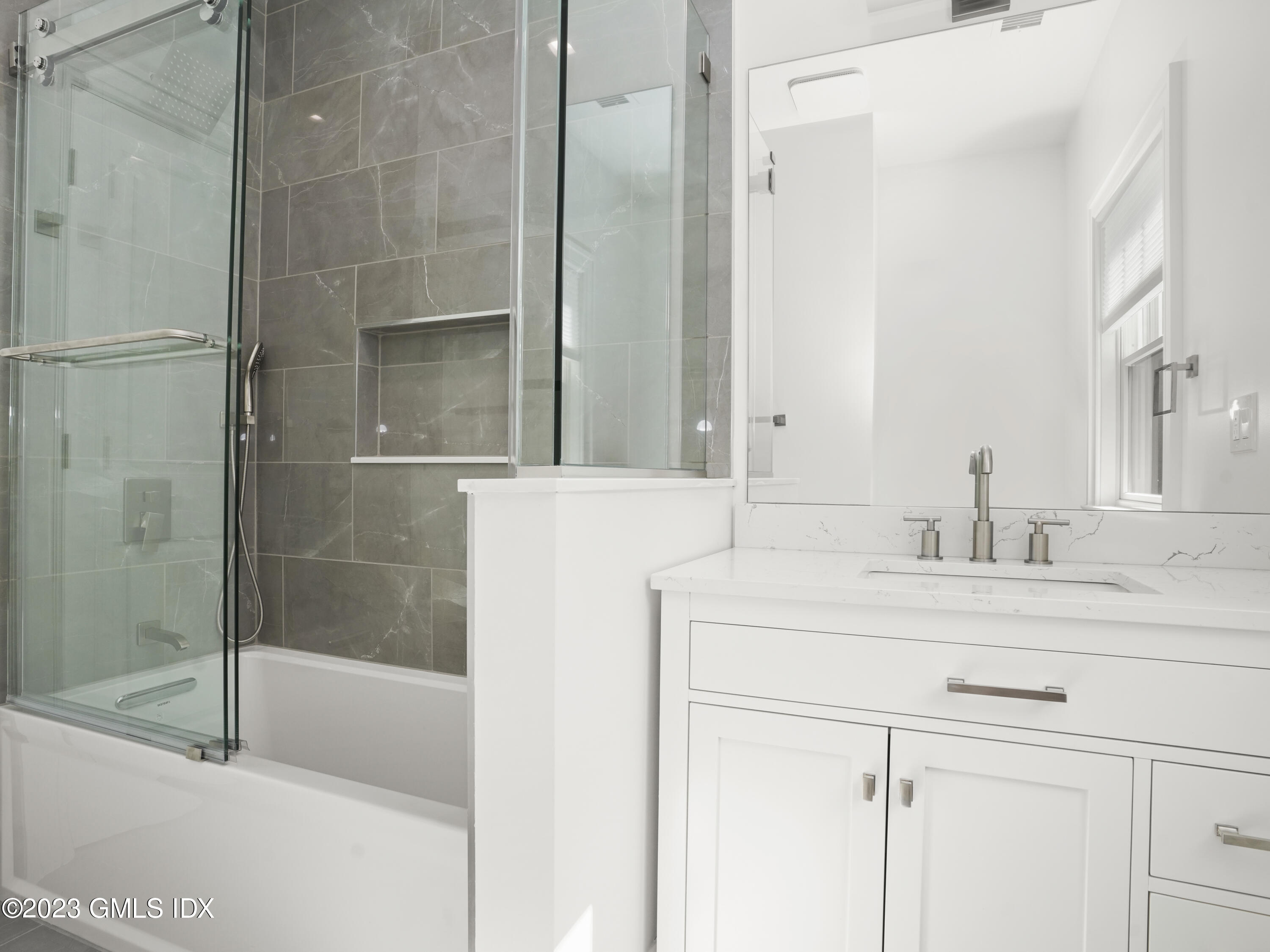 40 Butler Street Cos Cob, CT 06807 - Photo 14 of 27 a bathroom with a sink and a mirror