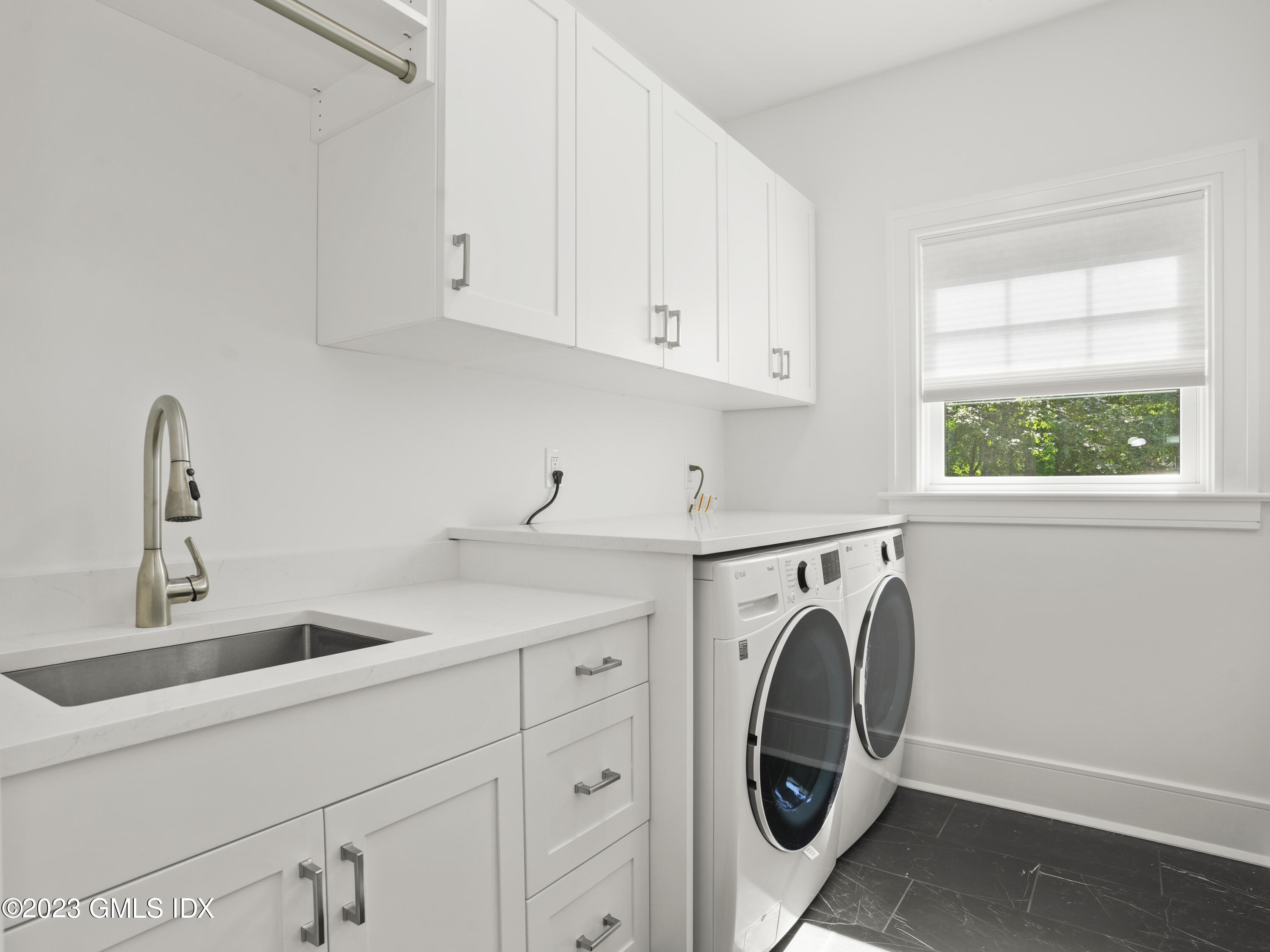 40 Butler Street Cos Cob, CT 06807 - Photo 15 of 27 a utility room with sink dryer and washer
