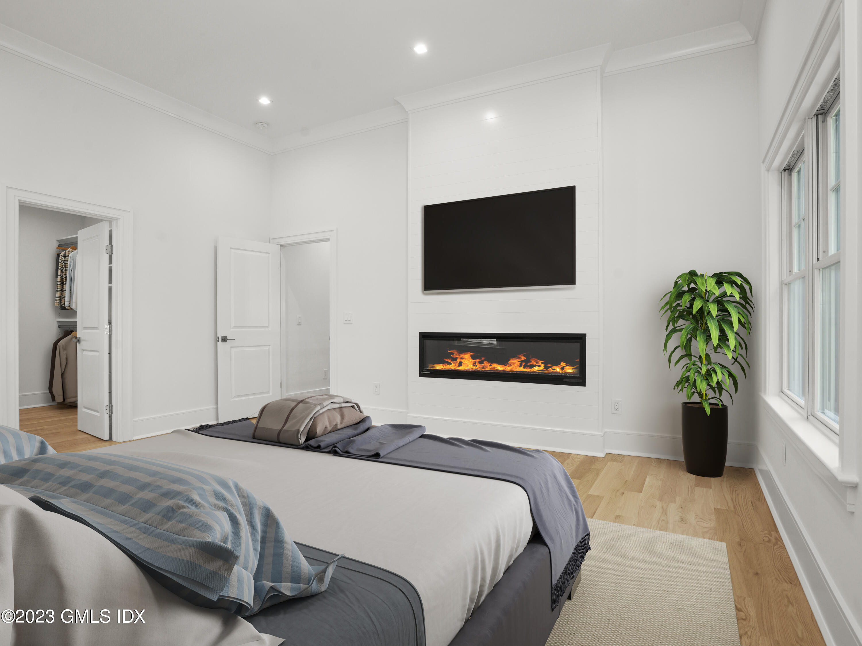 40 Butler Street Cos Cob, CT 06807 - Photo 17 of 27 a bedroom with a bed and a potted plant