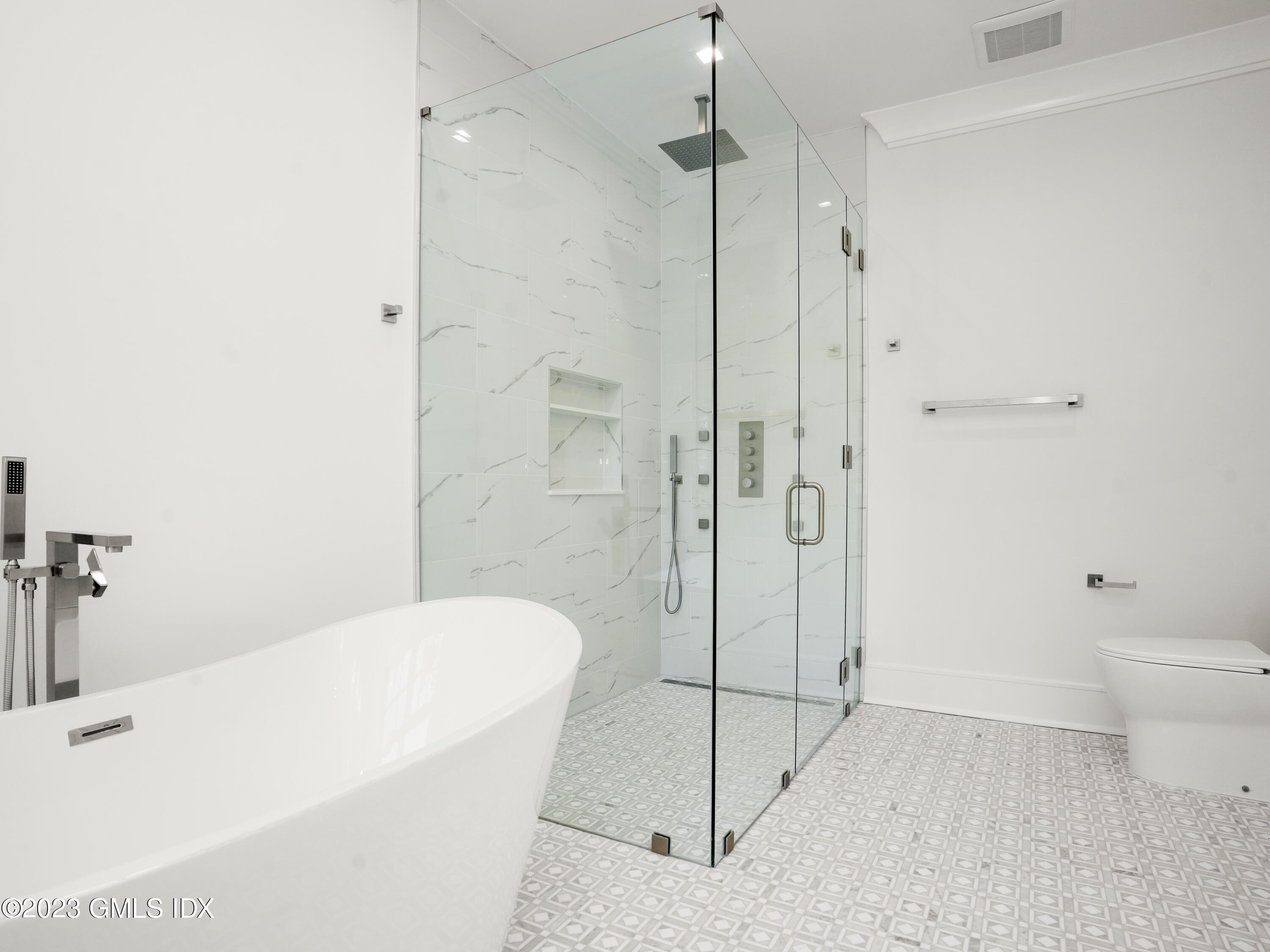 40 Butler Street Cos Cob, CT 06807 - Photo 20 of 27 a bathroom with a bathtub and a shower