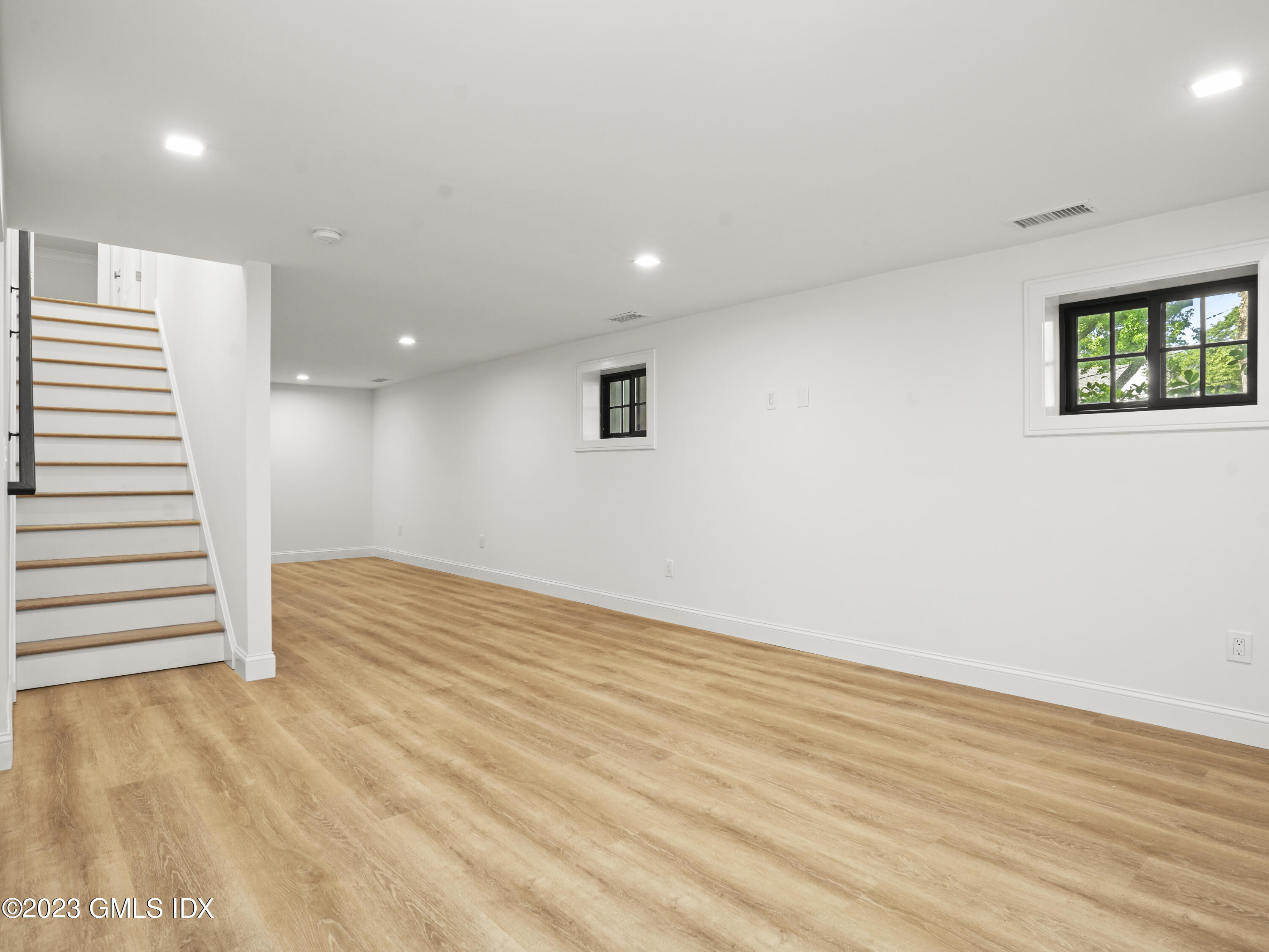 40 Butler Street Cos Cob, CT 06807 - Photo 21 of 27 an empty room with wooden floor and windows