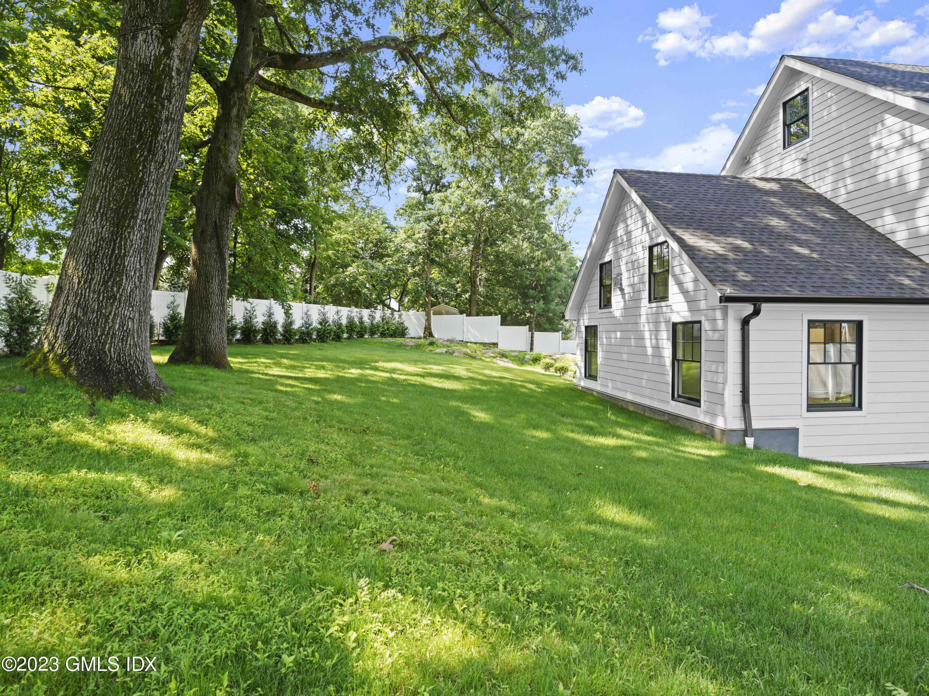40 Butler Street Cos Cob, CT 06807 - Photo 25 of 27 a backyard of a house with table and chairs