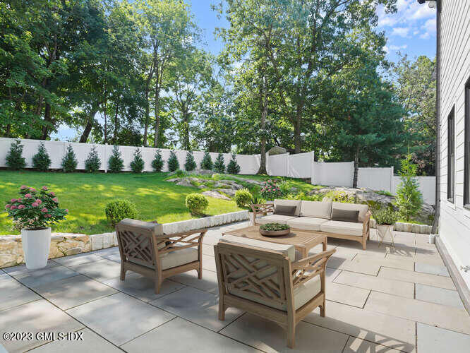 40 Butler Street Cos Cob, CT 06807 - Photo 26 of 27 a view of a patio with couches and a table and chairs with garden