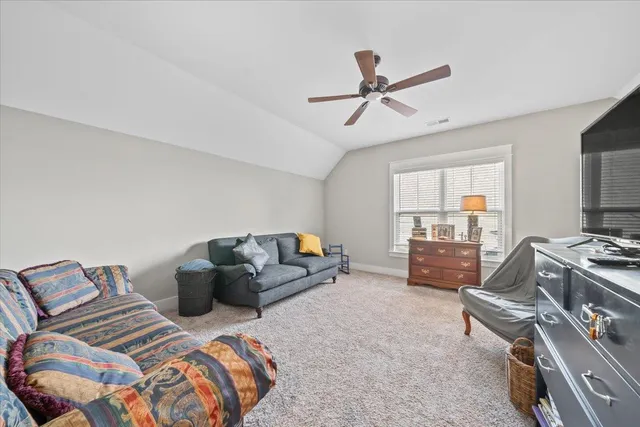 a bedroom with furniture and a wooden floor