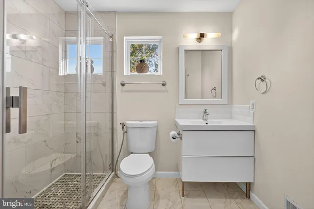 a bathroom with a sink toilet and shower