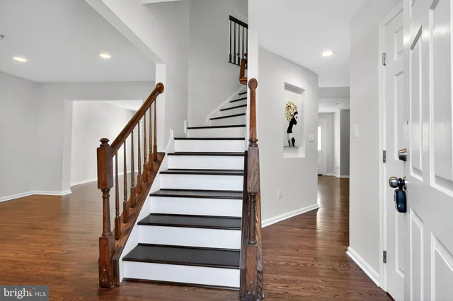 a view of entryway with wooden floor and stairs