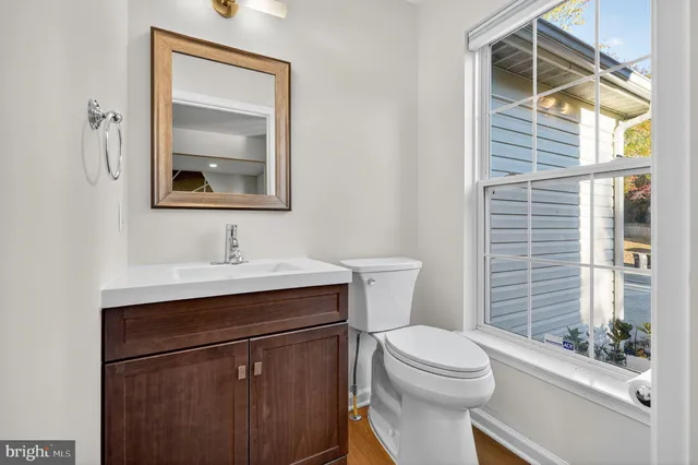 a bathroom with a toilet a sink and a window