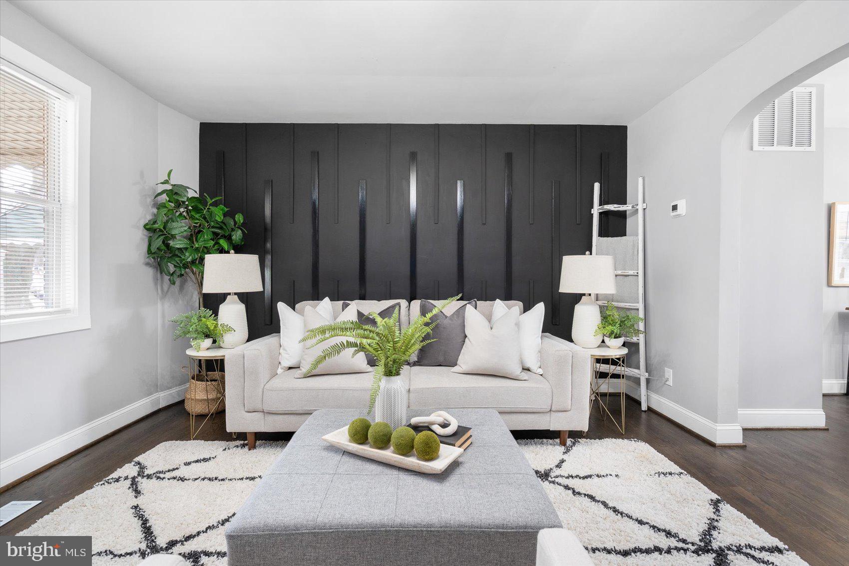 4208 Colborne Road Baltimore, MD 21229 - Photo 1 of 34 a living room with furniture and a potted plant