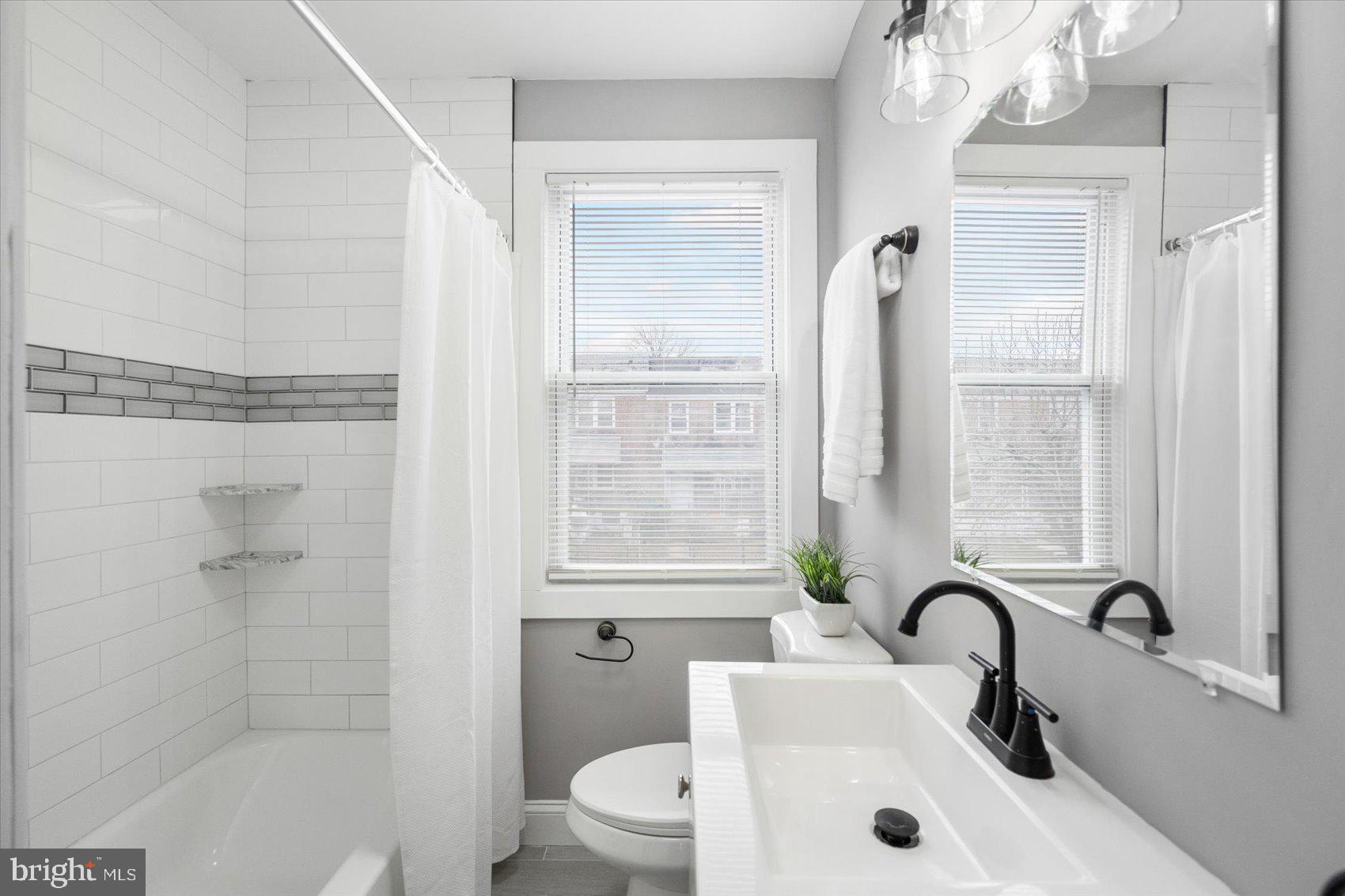 4208 Colborne Road Baltimore, MD 21229 - Photo 19 of 34 a bathroom with a sink toilet and shower