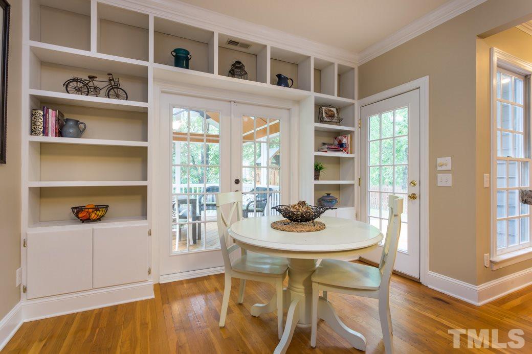 11729 Stannary Place Raleigh, NC 27613 - Photo 7 of 15 The breakfast room has a lot of shelving for your cook books and collectibles. The is a lot of natural light and the french doors lead out onto the SCREENED PORCH.