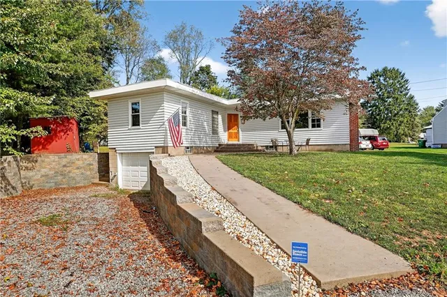a front view of a house with a yard