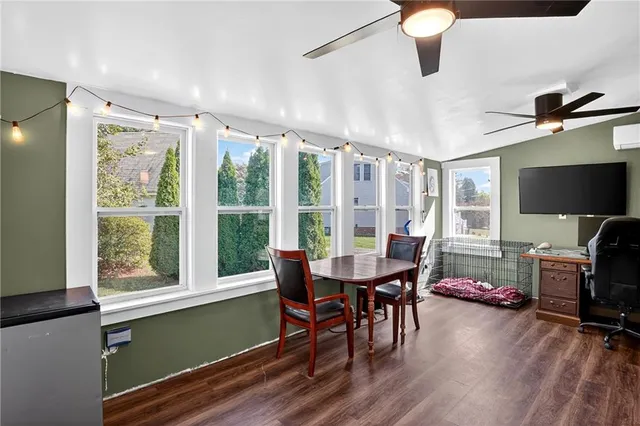 a view of a dining room with furniture window and wooden floor