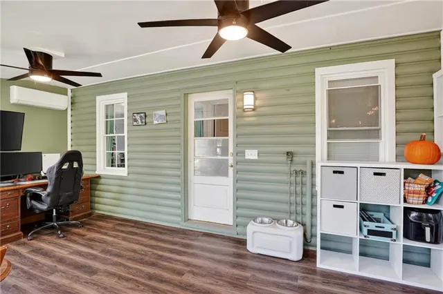 a view of workspace with wooden floor and windows