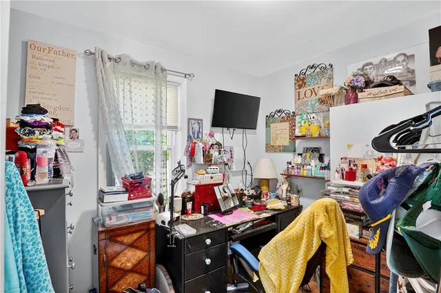 a view of a workspace with furniture and a window