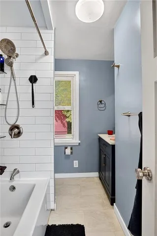 a bathroom with a tub a sink and a shower
