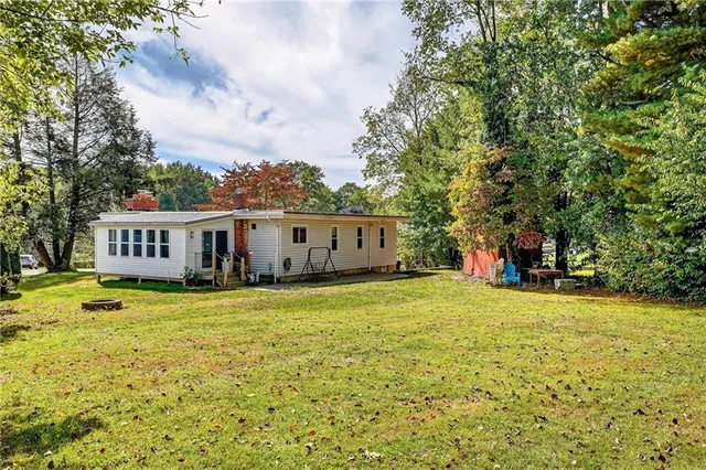 a house view with a sitting space and garden