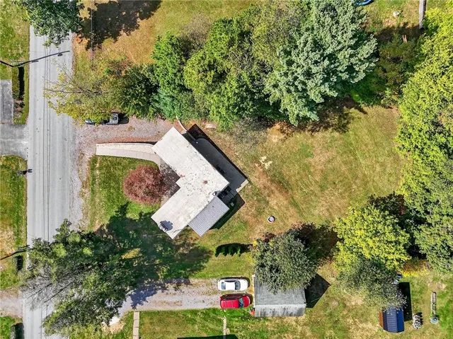 an aerial view of a house with swimming pool and garden