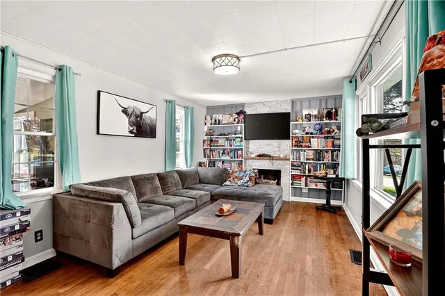 a living room with fireplace furniture and a flat screen tv