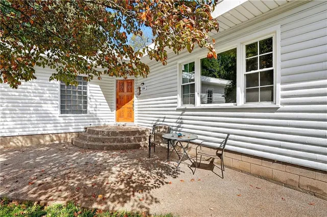 a backyard of a house with table and chairs