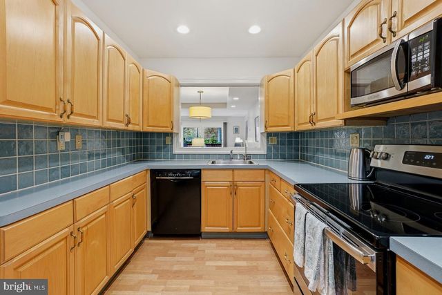 a kitchen with stainless steel appliances granite countertop a sink and cabinets
