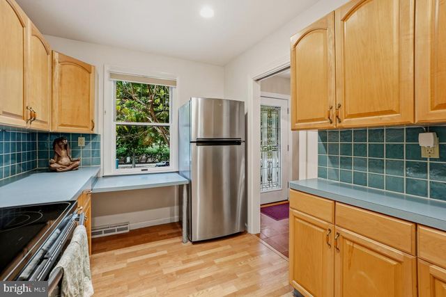 a kitchen with stainless steel appliances a refrigerator sink and cabinets