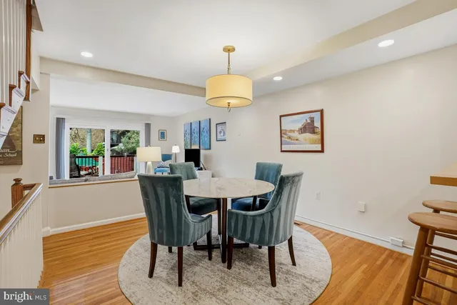 a dining room with furniture a chandelier and wooden floor