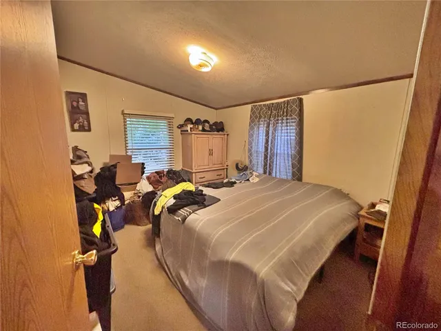 a bed sitting in a bedroom next to a window