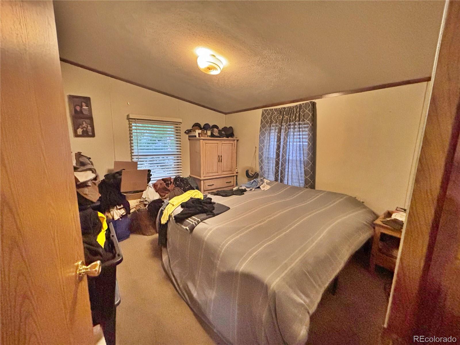 201 Pinto Street Golden, CO 80401 - Photo 11 of 22 a bed sitting in a bedroom next to a window