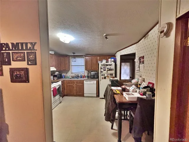 a living room with furniture and a kitchen