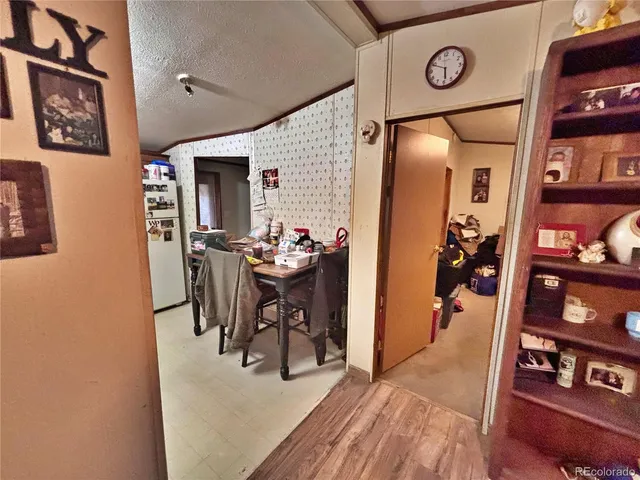 a view of a livingroom and a dining room with furniture and wooden floor