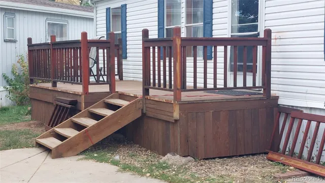 a view of a deck with wooden floor and fence