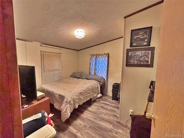 a bedroom with a bed window and television
