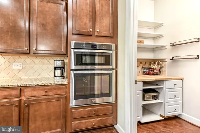 a kitchen with granite countertop cabinets and stainless steel appliances