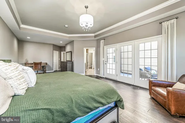 a spacious bedroom with a bed and a large window