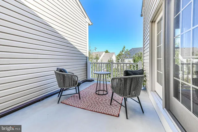a view of a patio with a table and chairs