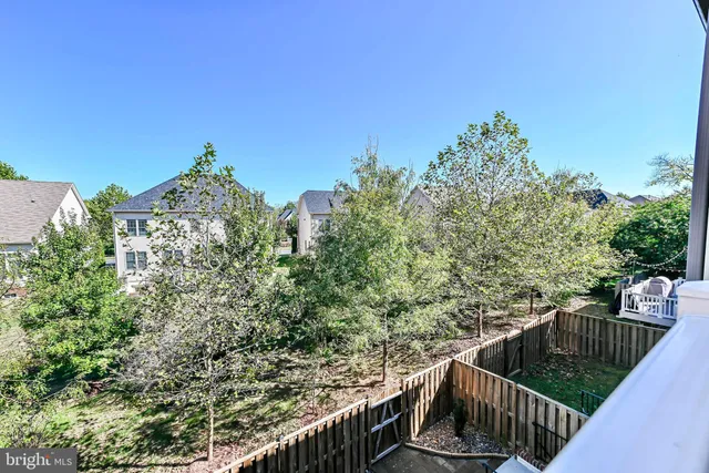 a view of balcony with wooden floor and fence