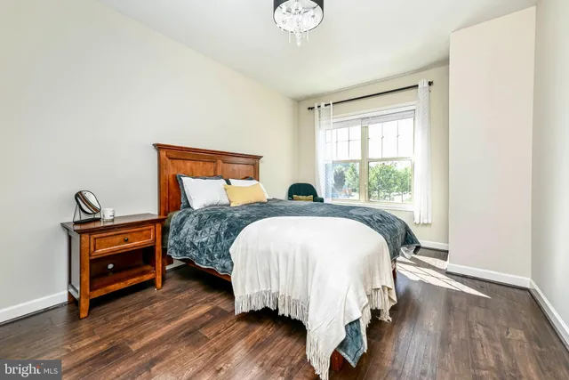 a bed sitting in a bedroom next to a window