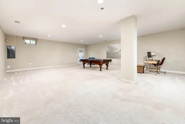 a view of work space with furniture and floor to ceiling window