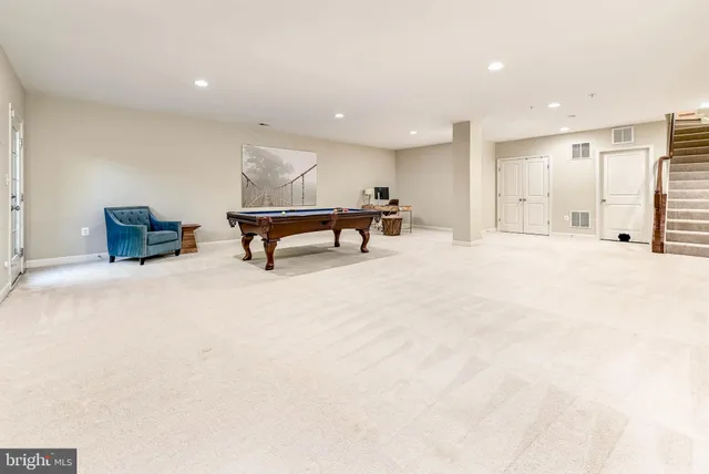 a view of a big room with windows and lounge chair