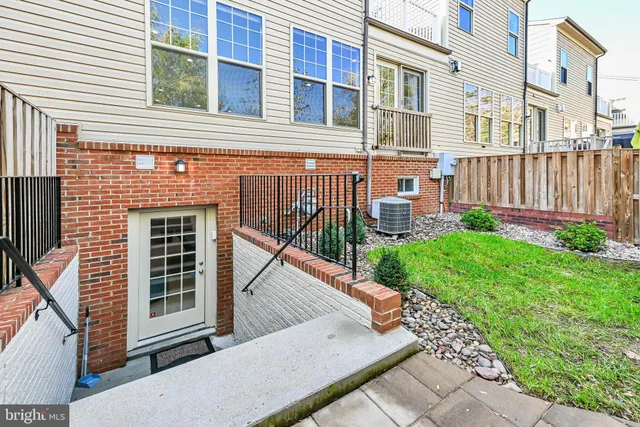 a view of a house with brick walls and a yard