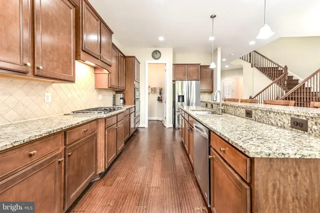 a kitchen with stainless steel appliances granite countertop counter space a sink and cabinets