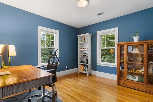 a view of a livingroom with furniture window and wooden floor