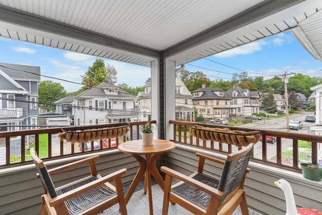 a view of a two chairs in the balcony
