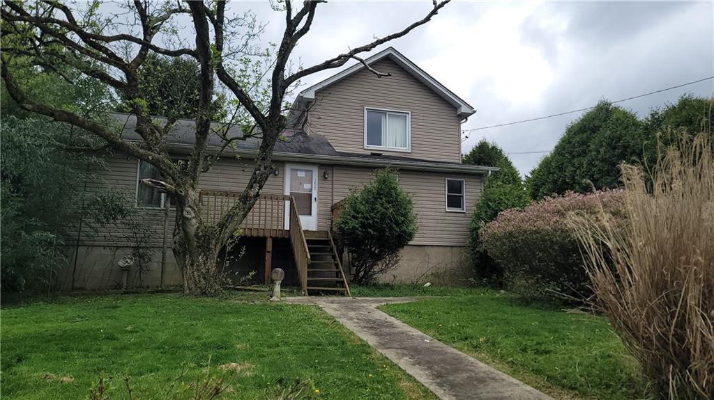 a view of a house with a yard and plants