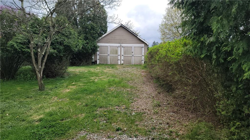 1314 George Street Coraopolis, PA 15108 - Photo 18 of 24 a view of a yard in front of a house with large trees