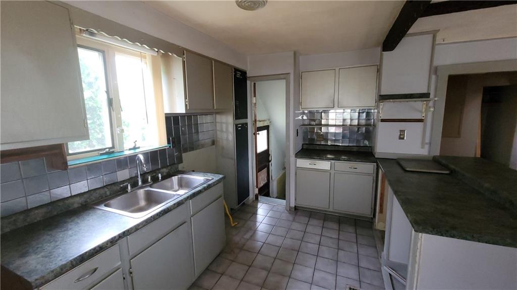 1314 George Street Coraopolis, PA 15108 - Photo 2 of 24 a kitchen with a sink stove and refrigerator