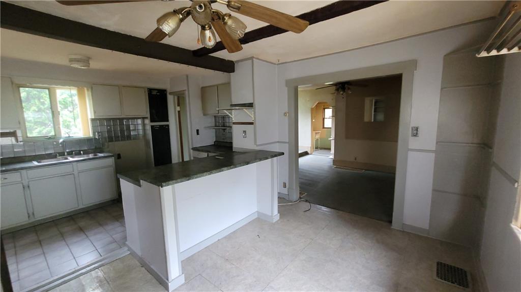 1314 George Street Coraopolis, PA 15108 - Photo 5 of 24 a kitchen with a sink and refrigerator
