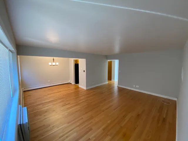 a view of an empty room and wooden floor